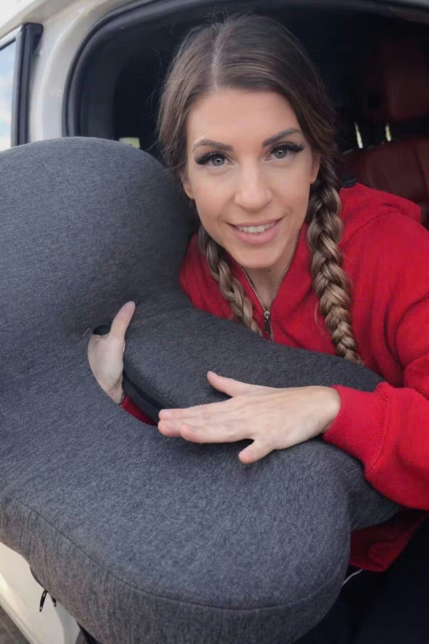 Customer holding the Celinva cushion by her car, breathable knit cover visible