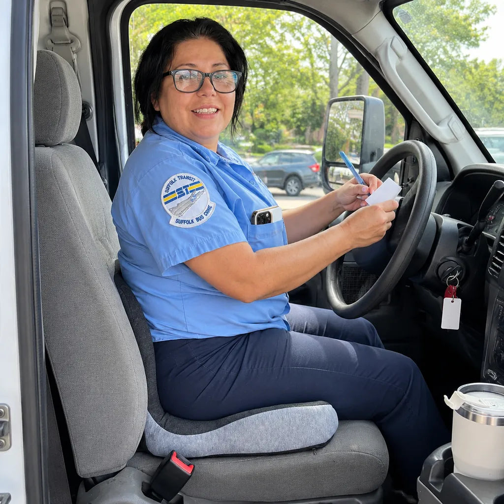Illustrative regenerated portrait of a woman seated on CELINVA in a parked vehicle.