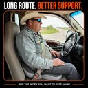 Illustrative long-haul driver seated with CELINVA in a parked cab.